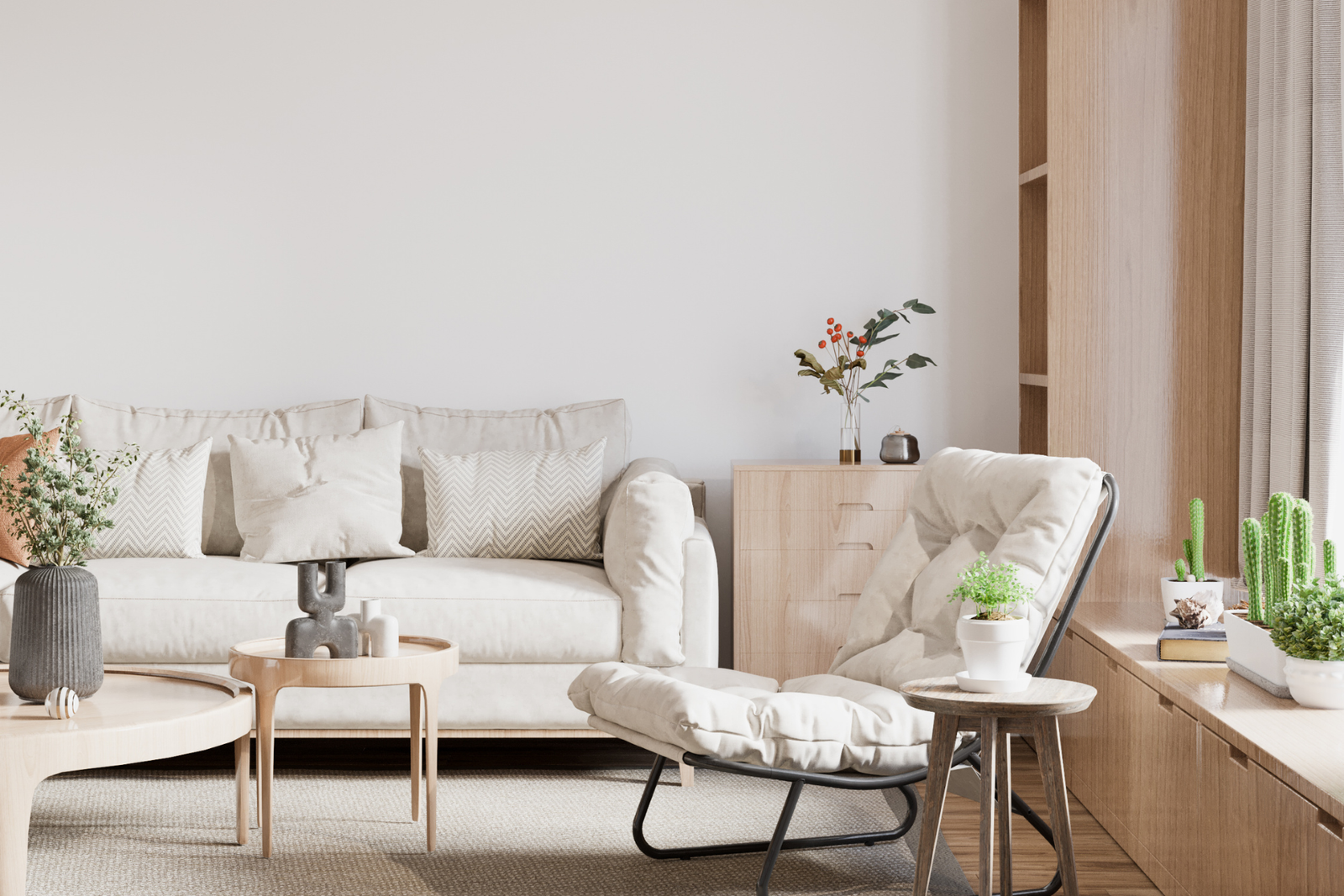 A minimalist living room with a neutral color palette, featuring a plush sofa, a comfortable armchair, and warm wooden furniture. The soft home furnishing textiles add to the cozy feel.