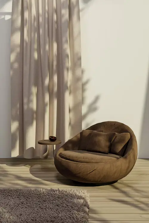 Two cozy retreats, a brown chair and a white daybed, showcasing the versatility of modern home furnishing textiles.